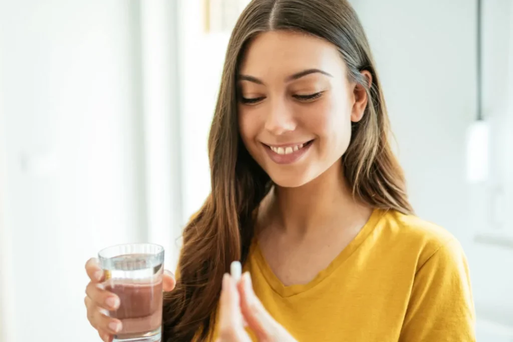 Lady having supplement. 