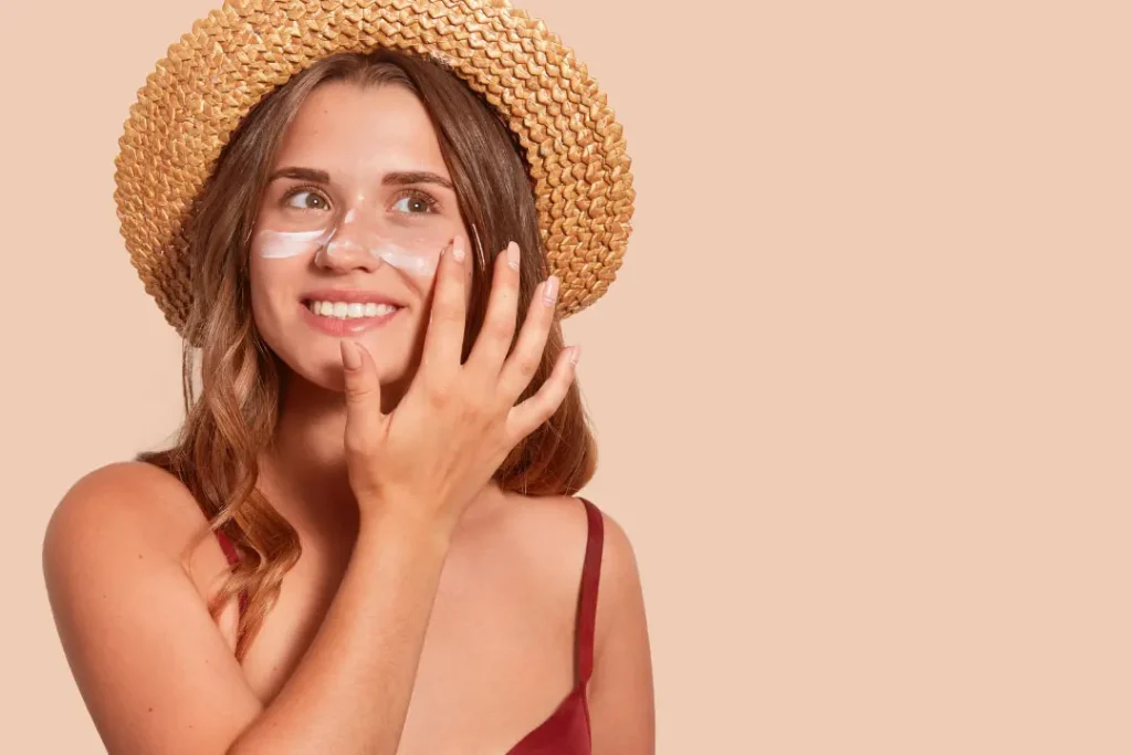 Lady applying cream on her face. 