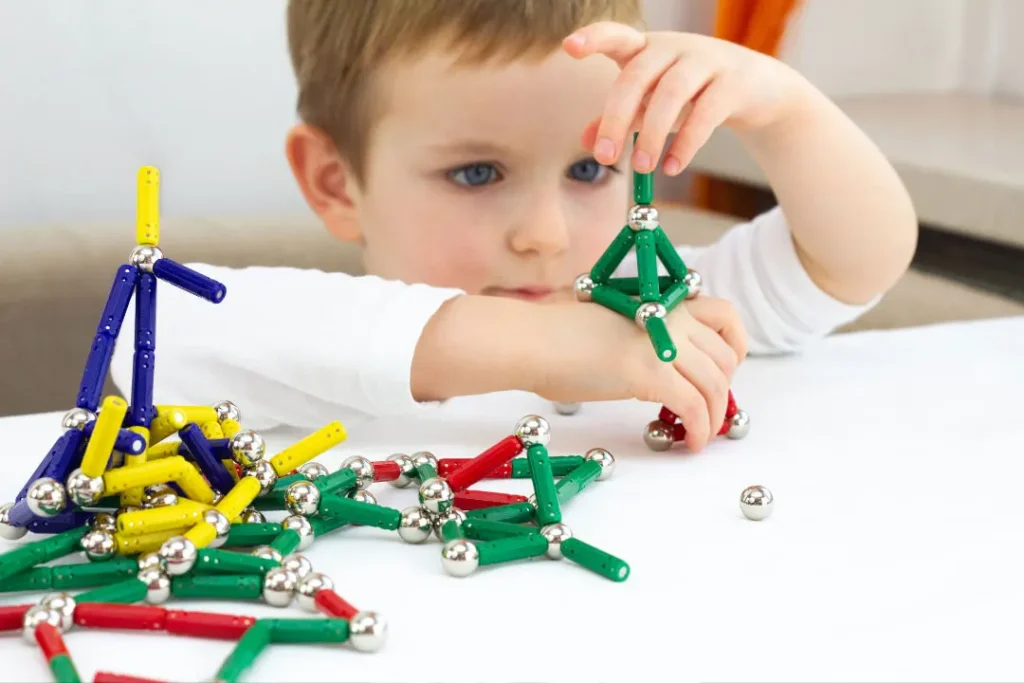 Child is playing with sticks. 