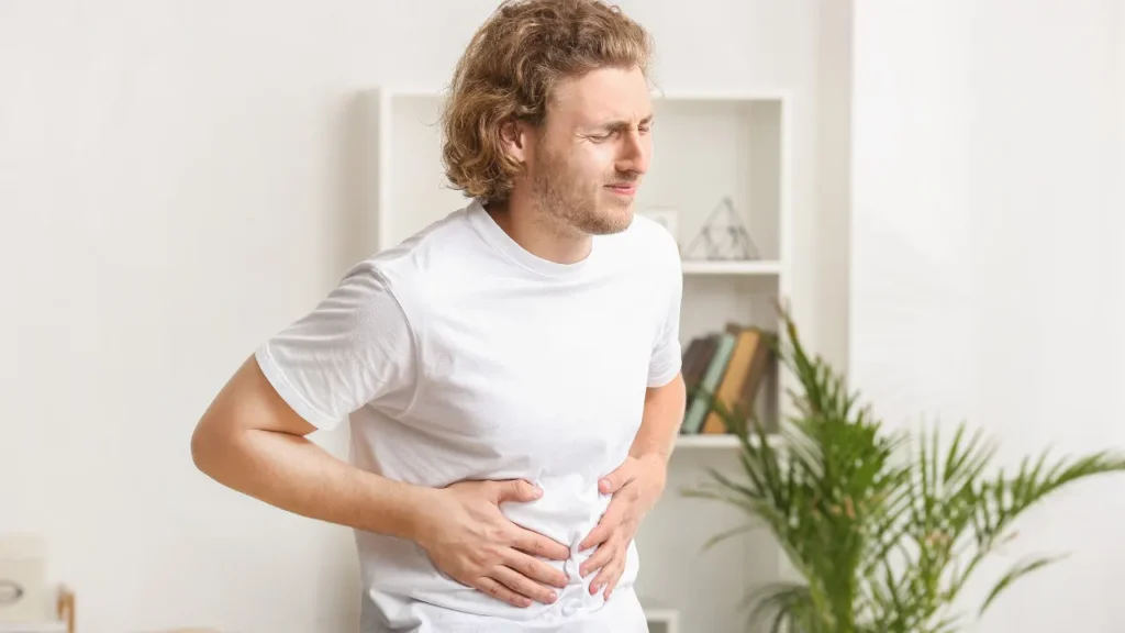 Young man having belly pain. 